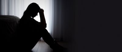 person sitting on the floor in a dark room