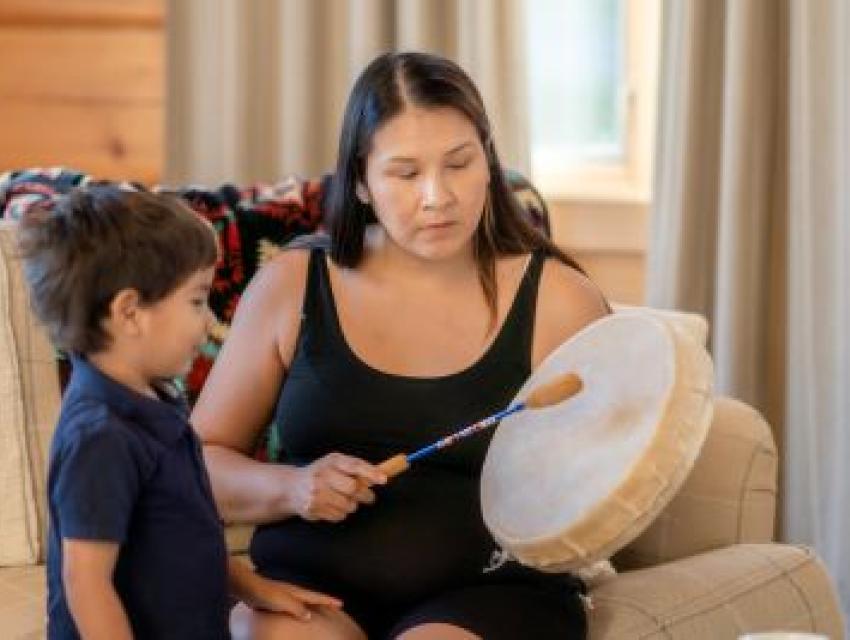 woman drumming with child