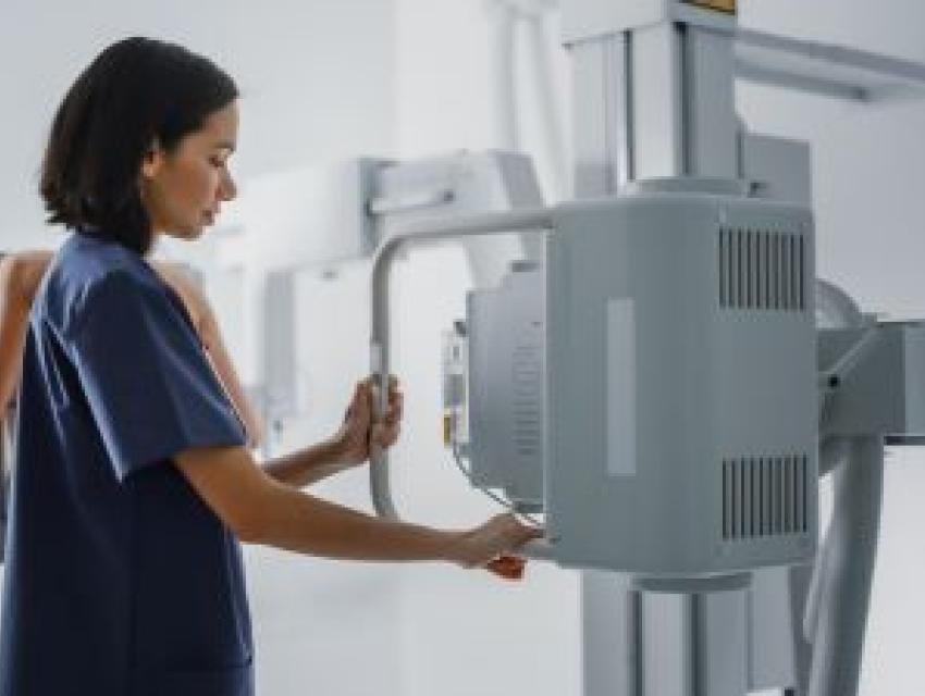 health care provider using a mammogram machine