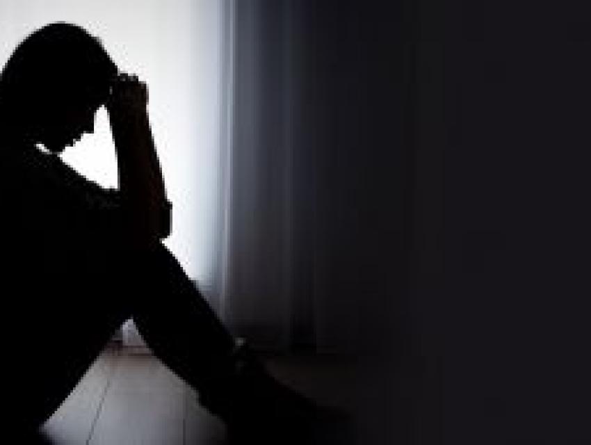 person sitting on the floor in a dark room