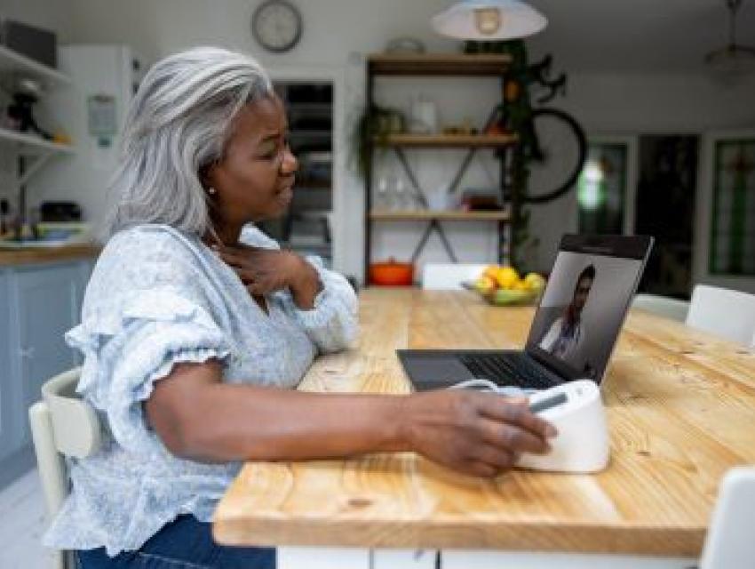 woman sitting down and looking at a computer